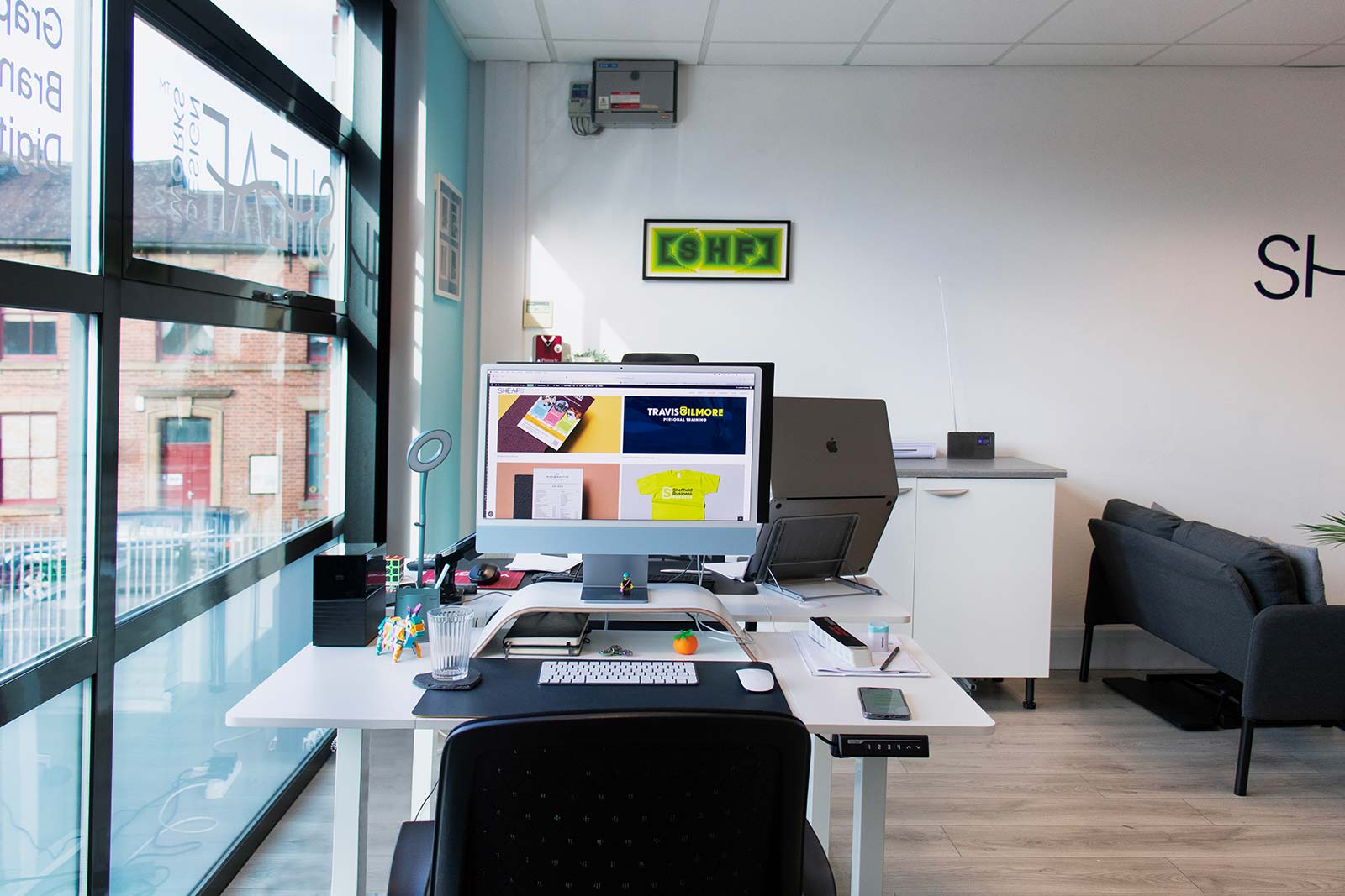 graphic-deisgn-work-displaye-don-apple-computers-in-the-design-studio graphic designer desk in a sheffield studio